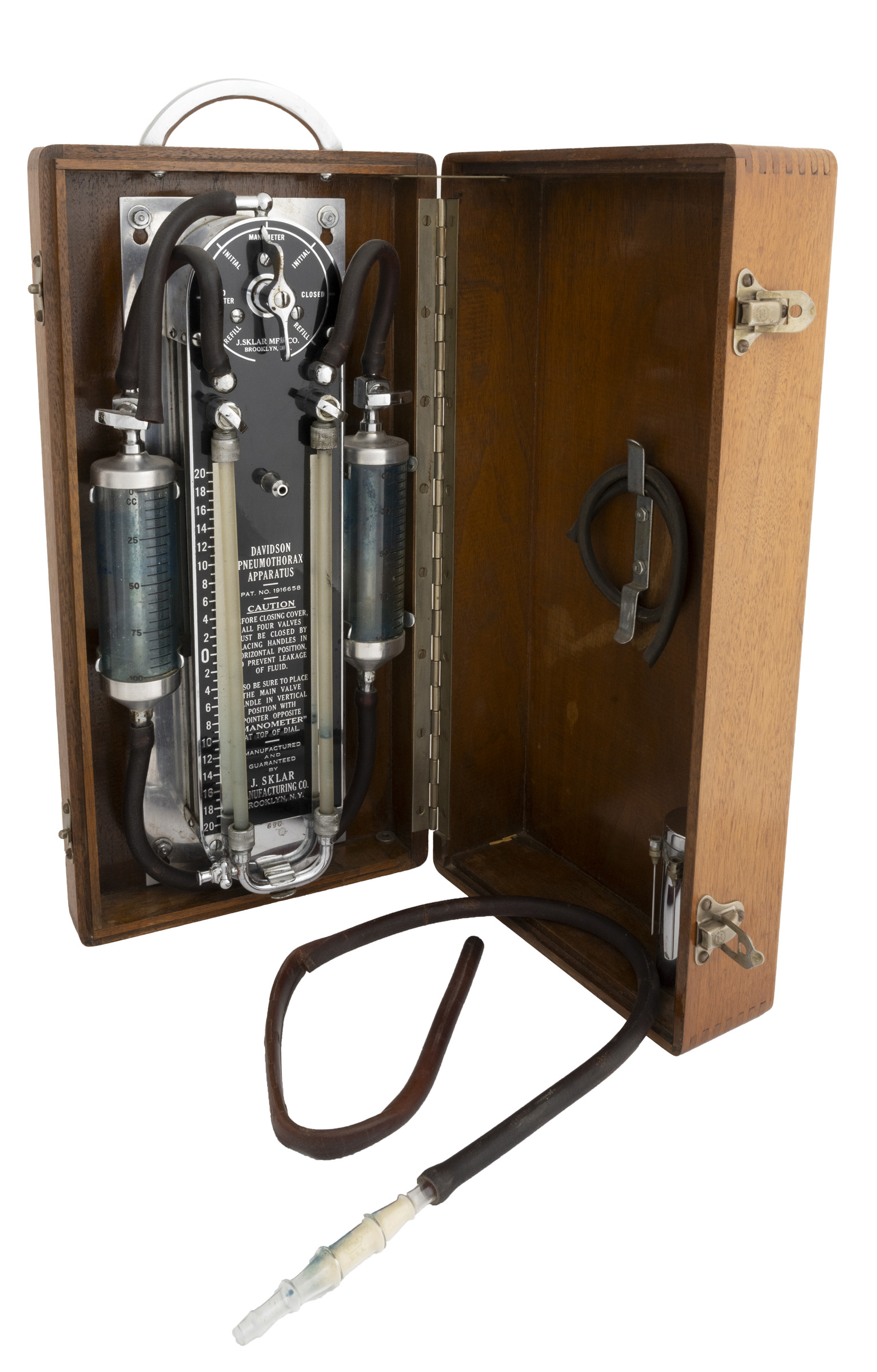 Open wooden case containing medical instrumentation.