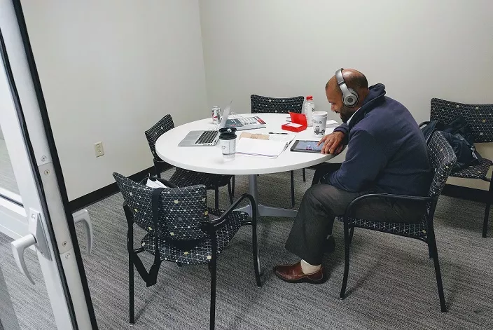 Man sitting at a round table studying