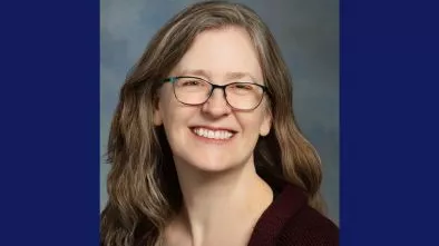 Portrait of Lissa Sloan with blue background