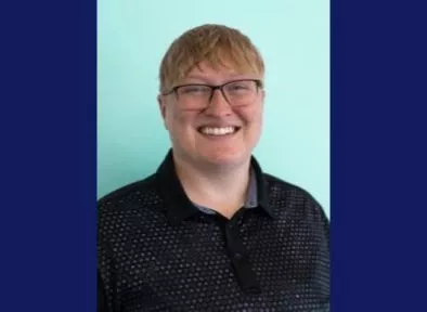 Portrait of Sal Cochran with blue background