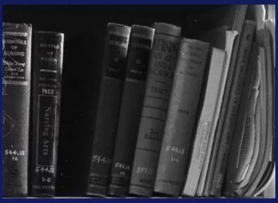 Black and white photo of medical books on a shelf